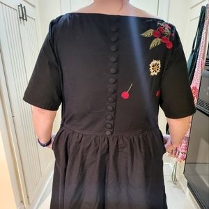 Size 26, fit and flare.  100% cotton.  Machine wash, cool dry.